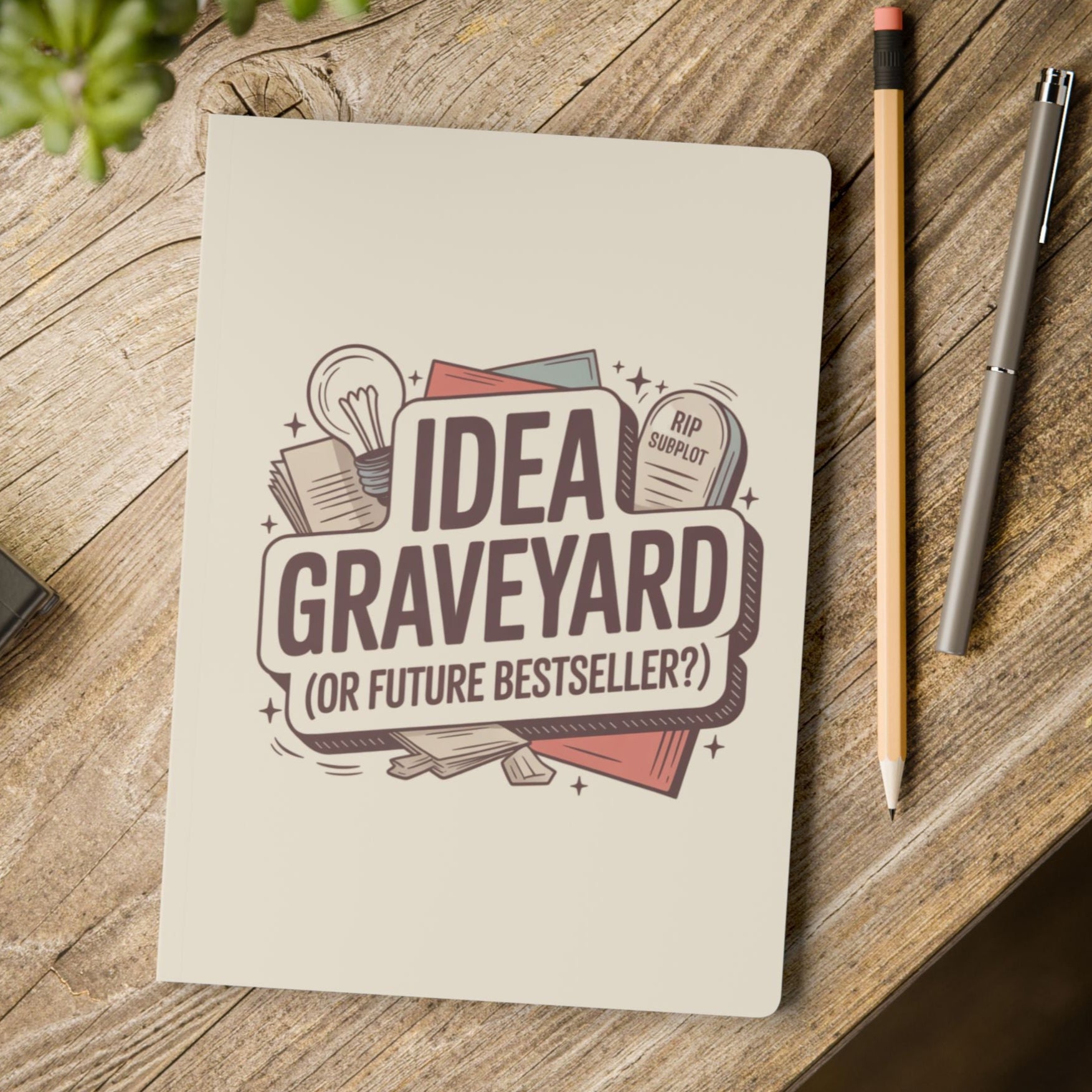 Notebook with 'Idea Graveyard (or future bestseller?)' design on a wooden surface with a pencil and pen.