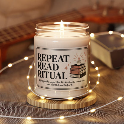 Candle in a jar with a label reading 'Repeat Read Ritual' on a wooden coaster, surrounded by string lights and a guitar in the background.
